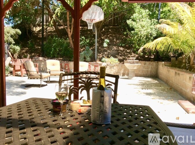 A table with a bottle and a glass of wine on it.