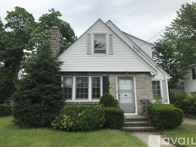 A house with a grey front door and a small porch.