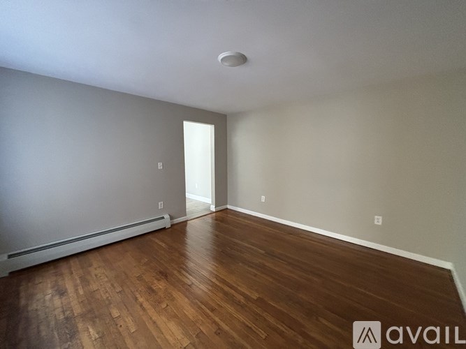 A room with wooden floors and a white ceiling.