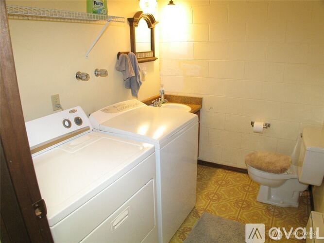 A small bathroom with a washer and dryer.