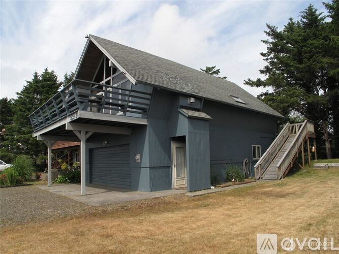 A house with a grey roof and a balcony.