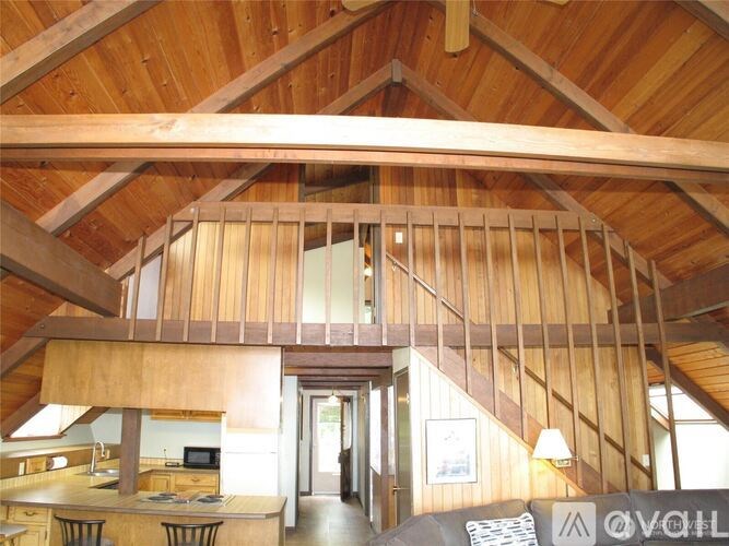 A wooden house interior with a staircase.