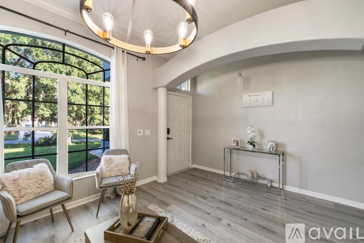 A living room with a grey sofa and a glass coffee table.