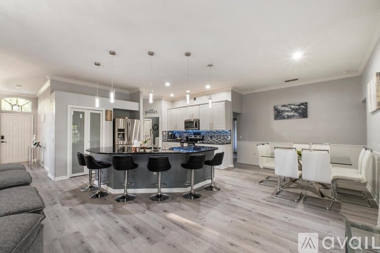 A modern kitchen with a bar area and seating.