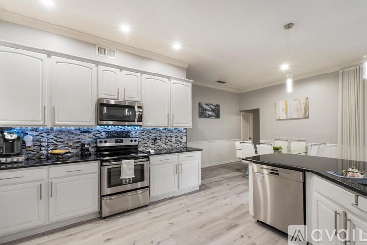 A modern kitchen with a stove top oven and a microwave built into the cabinetry.