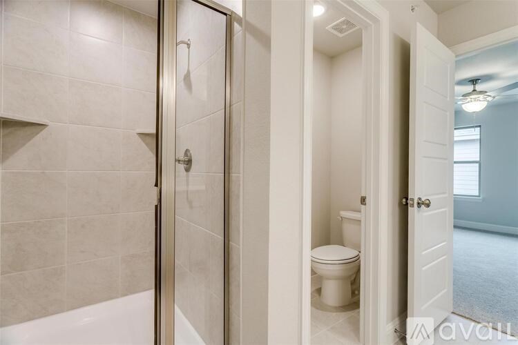 A bathroom with a toilet and a walk-in shower.