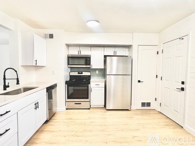 A kitchen with white cabinets and stainless steel appliances.