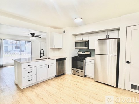 A kitchen with white cabinets and stainless steel appliances.