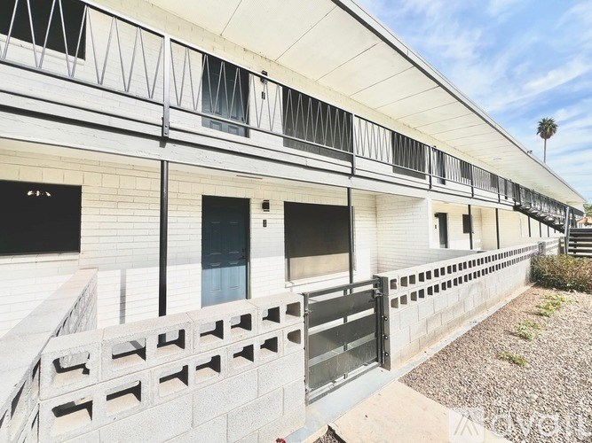A white building with black railings and windows.