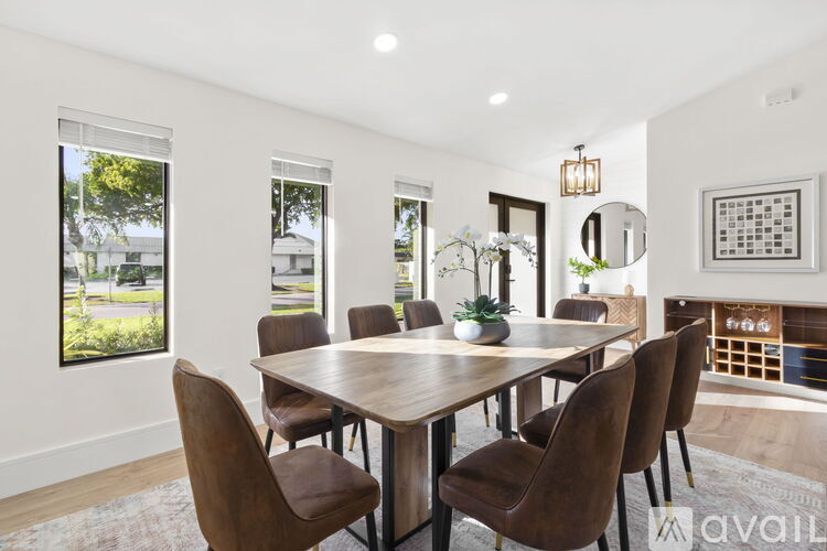 A modern dining room with a wooden table and chairs.
