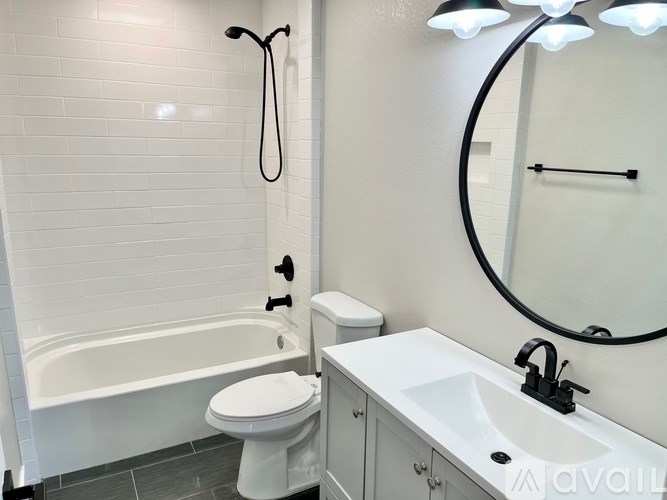 A white bathroom with a toilet, sink, and tub.