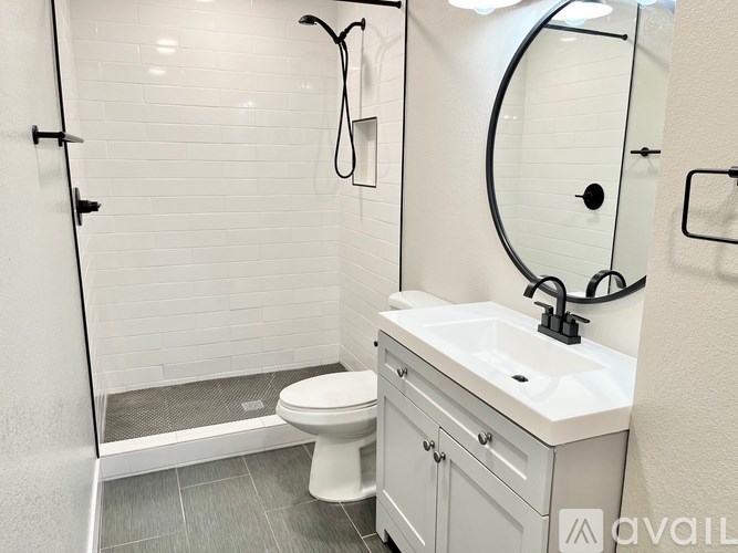 A white toilet sits next to a sink in a bathroom.