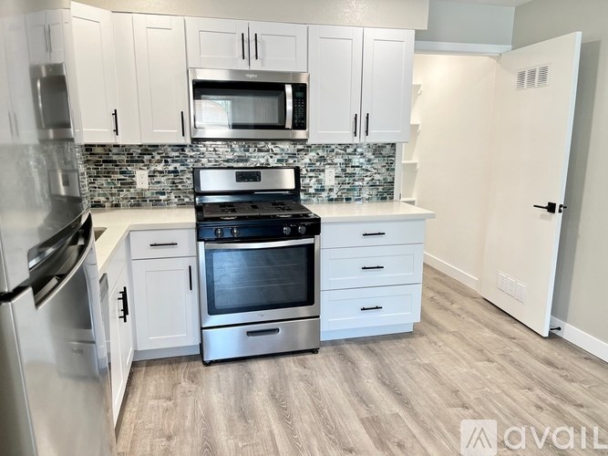 A kitchen with a stove top oven and a microwave above it.