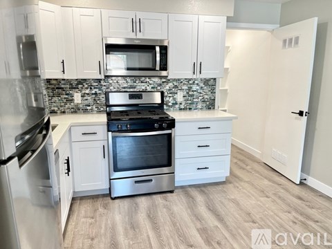 A kitchen with a stove top oven and a microwave above it.