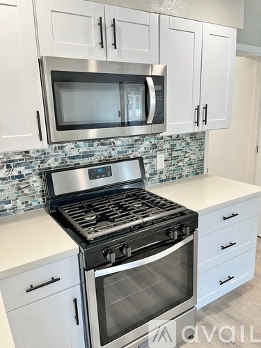 A kitchen with a stove top oven and microwave above it.