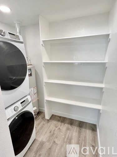 A small laundry room with a washer and dryer.