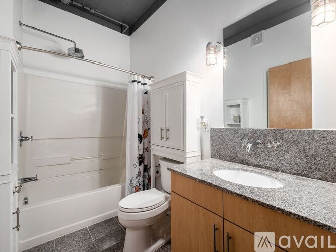 A bathroom with a toilet, sink, and shower.