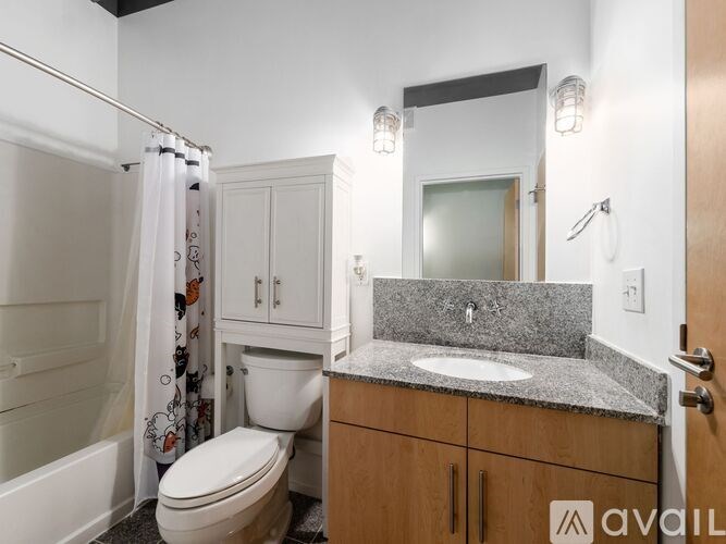 A bathroom with a toilet, sink, and shower.