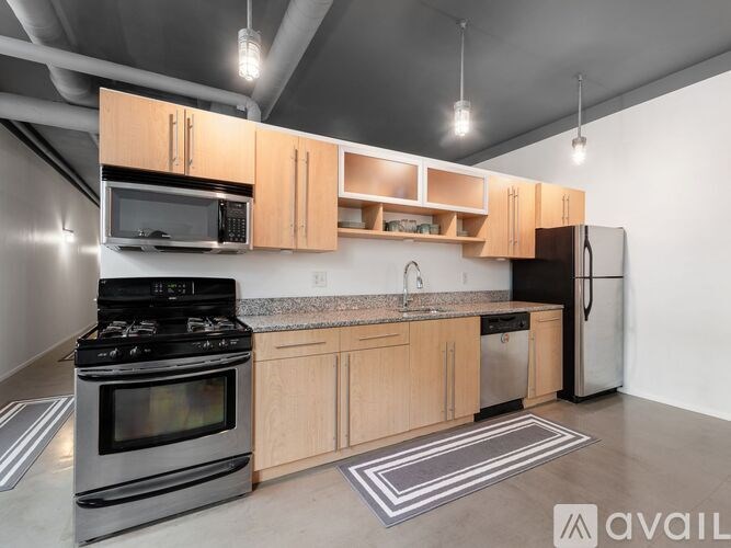 A kitchen with wooden cabinets and a black stove top oven.