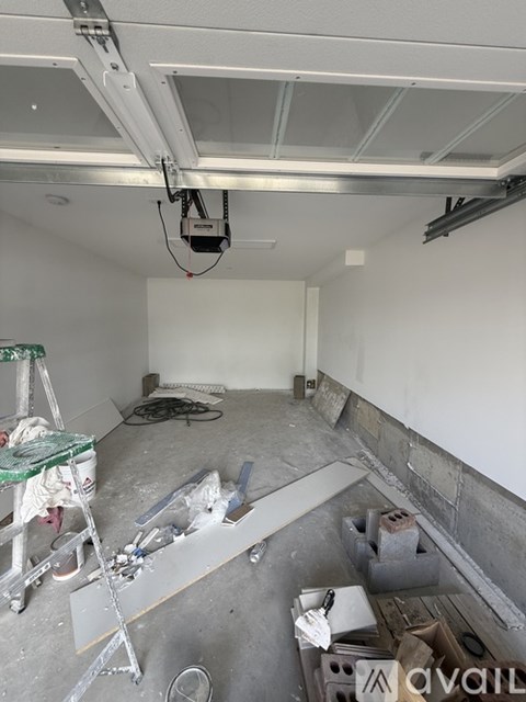 A room under construction with a lot of tools and materials scattered around.