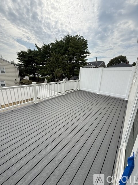 A spacious room with a staircase leading to the upper floor.