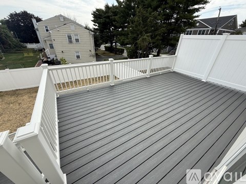 A kitchen with white cabinets and a wooden floor.