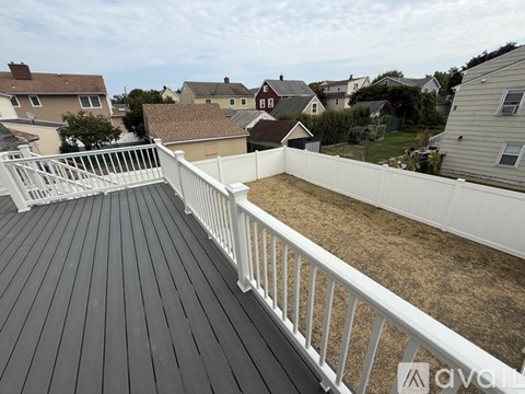 A room with a sliding glass door leading to a deck.