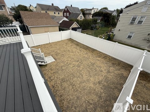 A construction site with a white fence and a dirt ground.