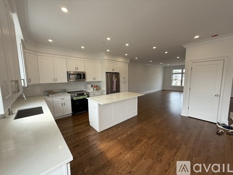 A spacious room with a staircase leading to the upper floor.