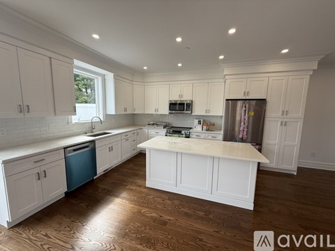 A wooden staircase with white railings in a house under construction.
