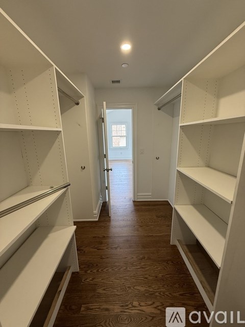 Two white washing machines with the door of the one on the right broken.