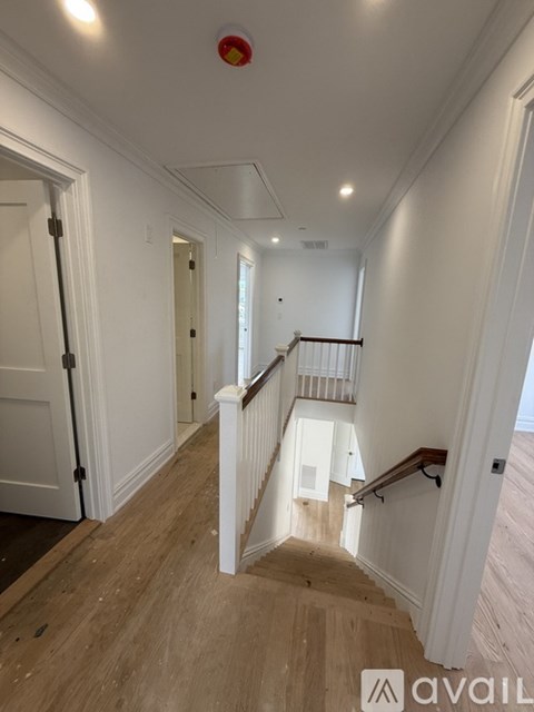 A hallway with a staircase leading to the second floor.