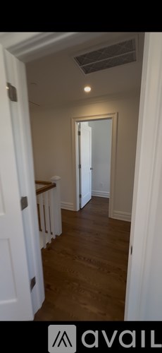 A room with a staircase leading to another room.