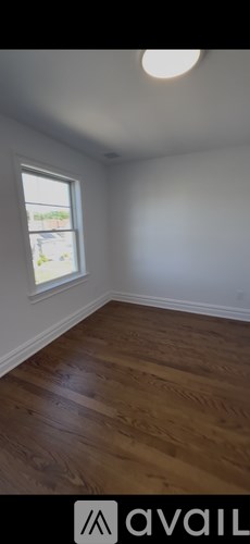 A room with white walls and a white door is being painted.
