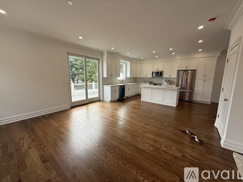A spacious room with a staircase leading to the upper floor.