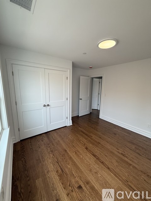A room with wooden floors and white walls.