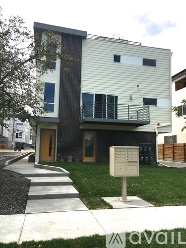 A modern two-story building with a balcony on the second floor.