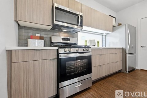 A kitchen with wooden cabinets and stainless steel appliances.