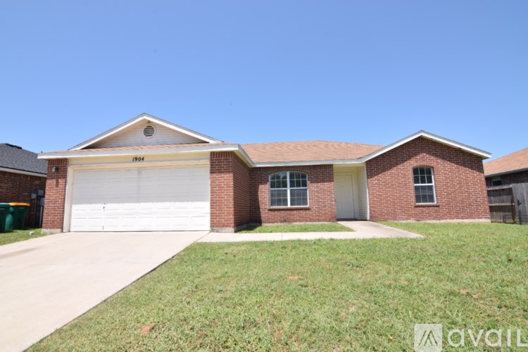 A house with a garage and a driveway in front.