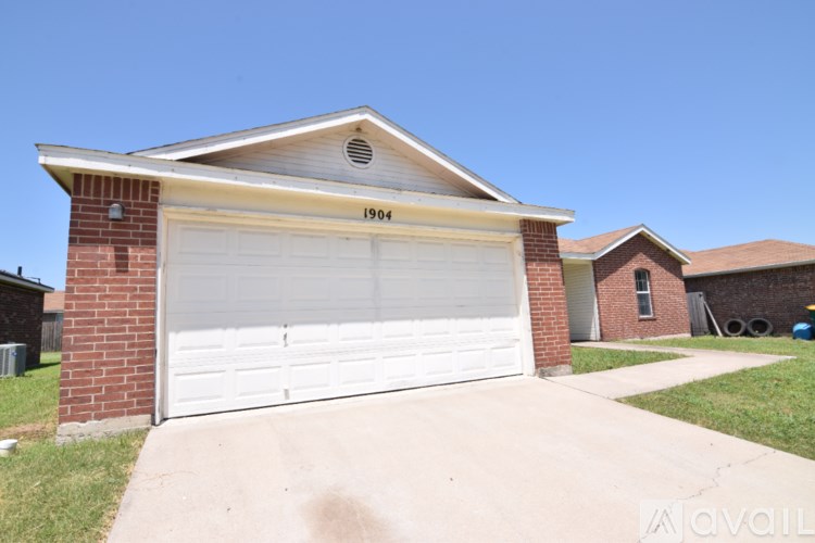 A house with a garage door that says 1904 on it.