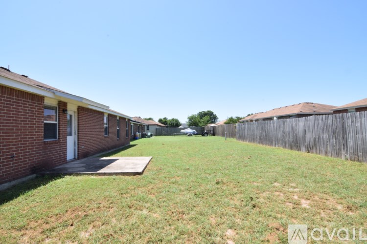 A row of houses with a grassy area in between.