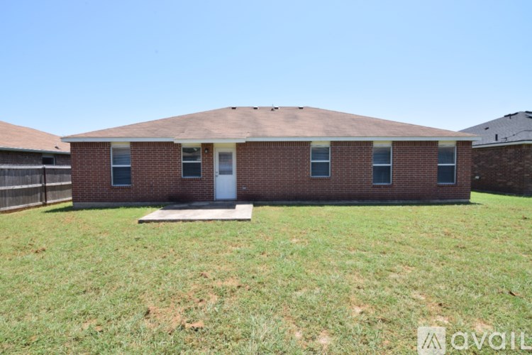 A brick house with a white door and windows is for sale.