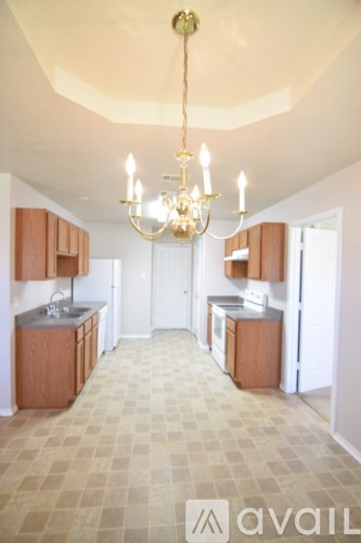 A kitchen with a checkered floor and a chandelier hanging from the ceiling.