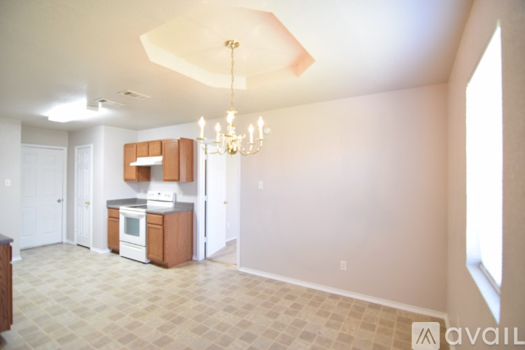 A kitchen area with a white oven and a tiled floor.