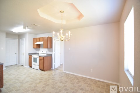 A kitchen area with a white oven and a tiled floor.