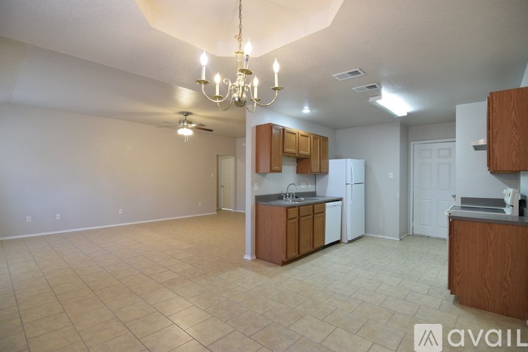 A spacious room with a ceiling fan and light fixture.