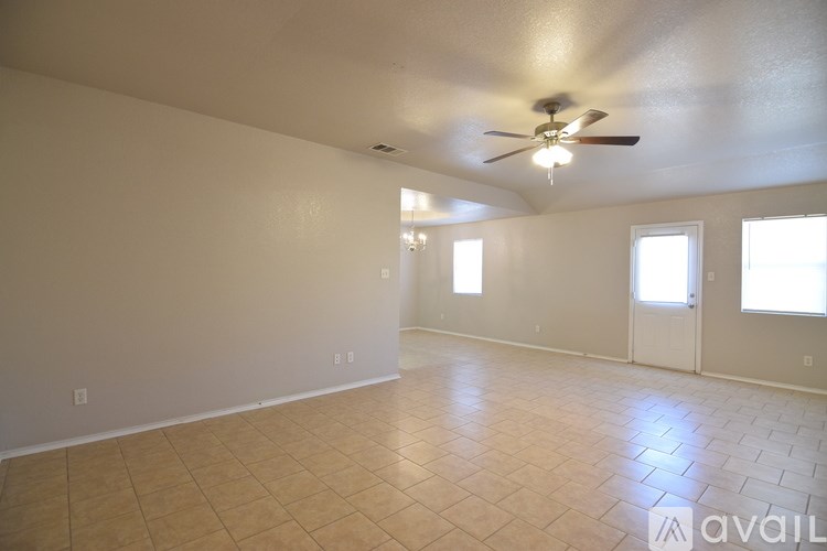 A bathroom with a tiled floor and a white door.