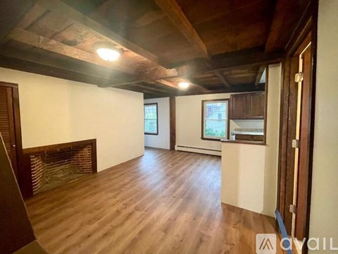 A room with wooden floors and a fireplace.