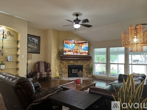 A living room with a fireplace and a television.