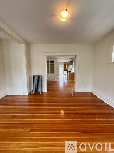 A room with wooden floors and white walls.